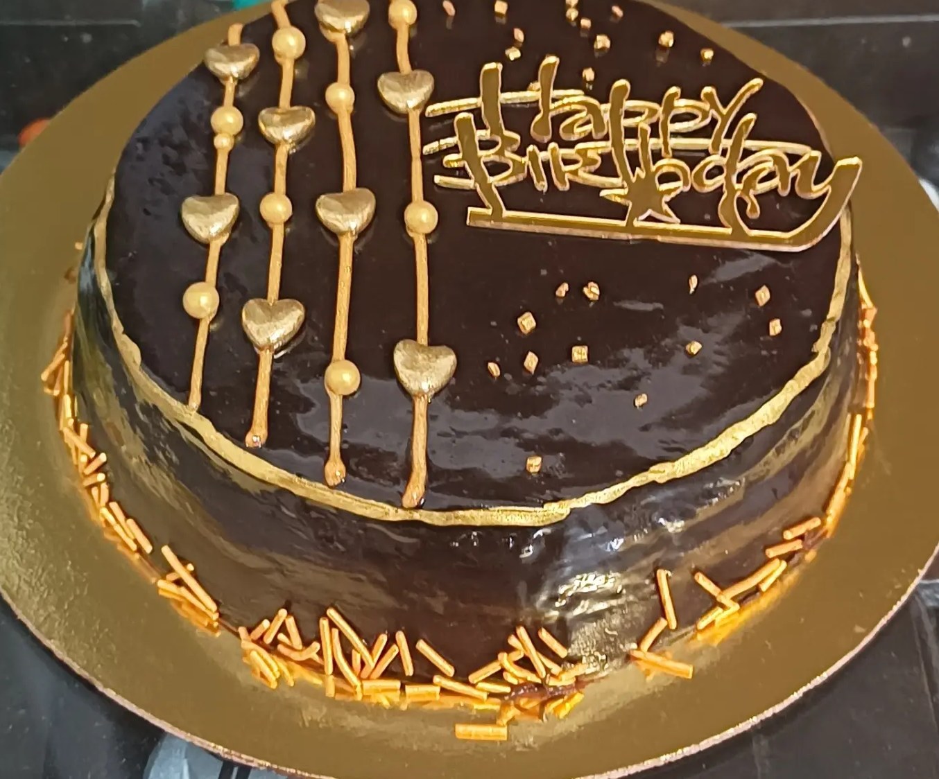 Chocolate truffle cake with gold hearts